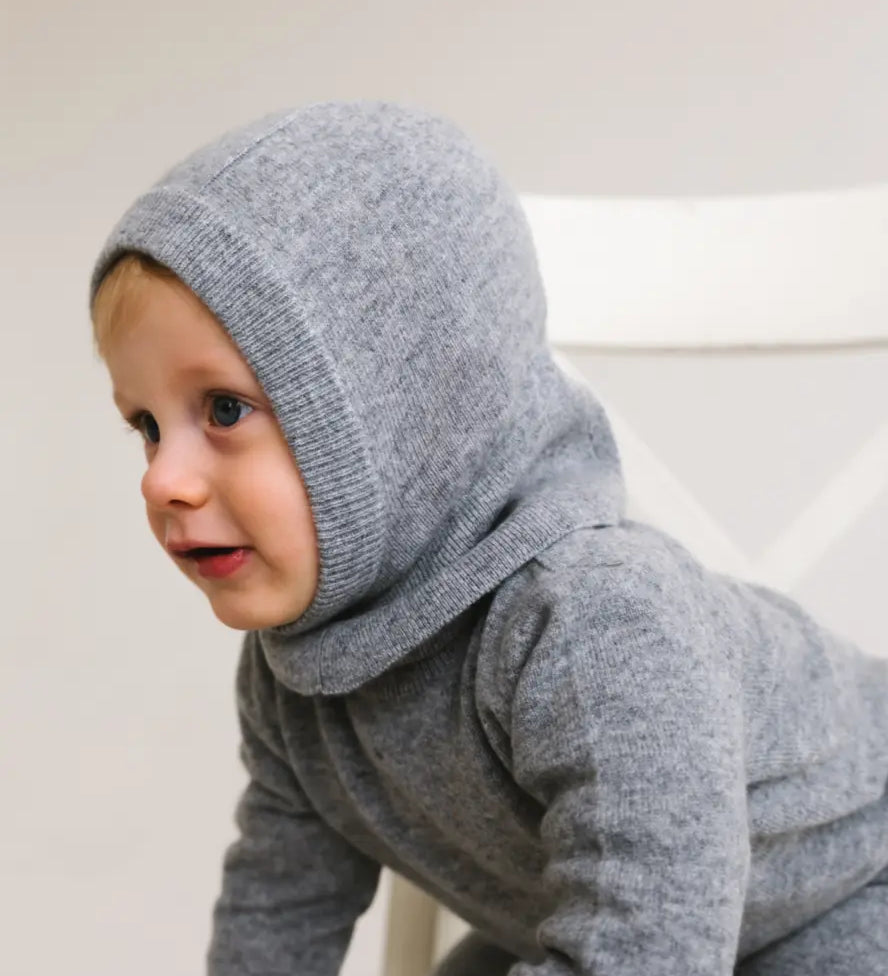 Side view of toddler wearing heather grey cashmere balaclava keeping head and ears warm.